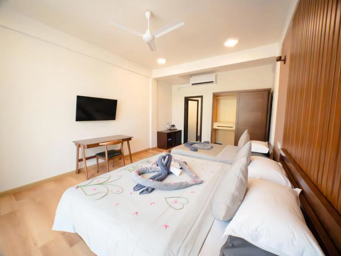 Experience beachfront bliss with a touch of Maldivian charm at Ahola Thoddoo. This guest house offers comfortable rooms, some with balconies