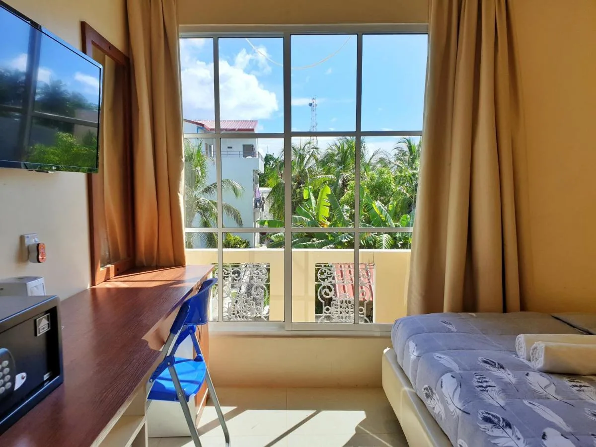 Immerse yourself in island life with a touch of luxury at Hulhangu Lodge. This modern guest house offers stylish rooms with balconies, an infinity pool with breathtaking ocean views, and a rooftop restaurant serving delicious meals.