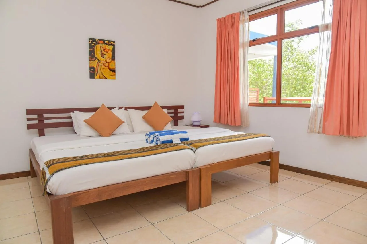 Embrace Maldivian hospitality at Kanbili Guest House. This family-run guest house offers comfortable rooms, a warm atmosphere, and delicious local cuisine prepared with fresh ingredients.