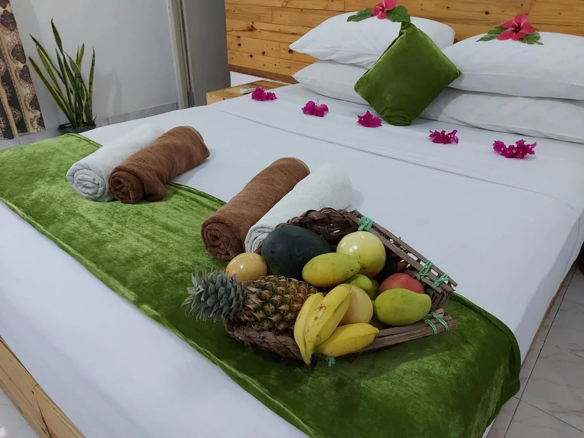 Embrace island charm at Veli Thoddoo Inn. This family-run guest house offers comfortable rooms, a warm atmosphere, and delicious local cuisine prepared with fresh ingredients.