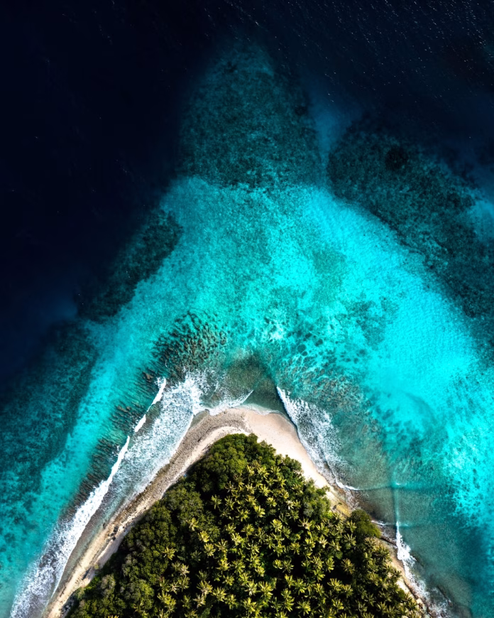 Aerial view of Maalhos Island, Maldives – white sandy beaches, turquoise lagoon, and lush palm trees in Baa Atoll UNESCO Biosphere Reserve